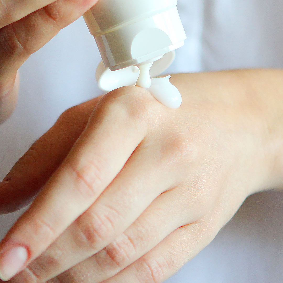 Take a generous amount of sunscreen body lotion